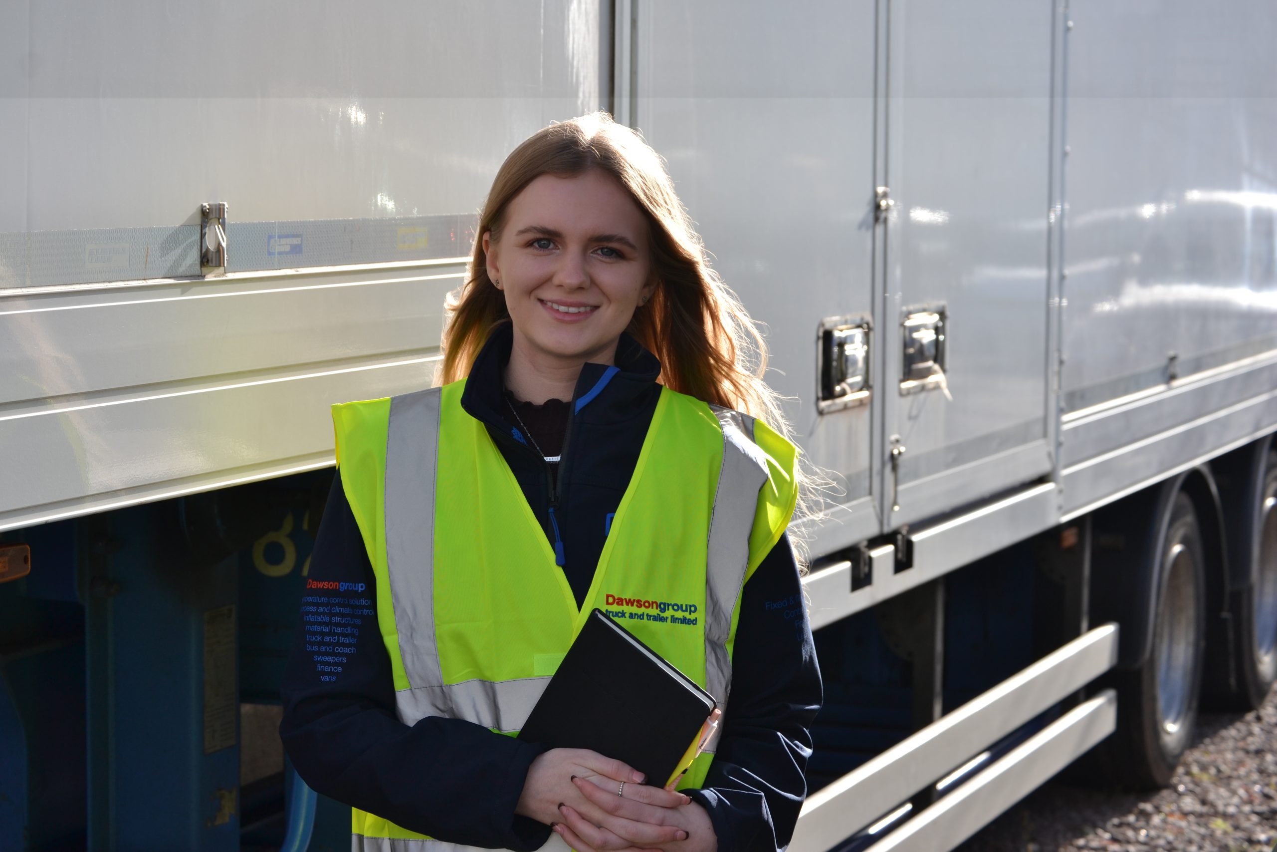 Commercial Motor Award woman in high vis jacket in front of trailer