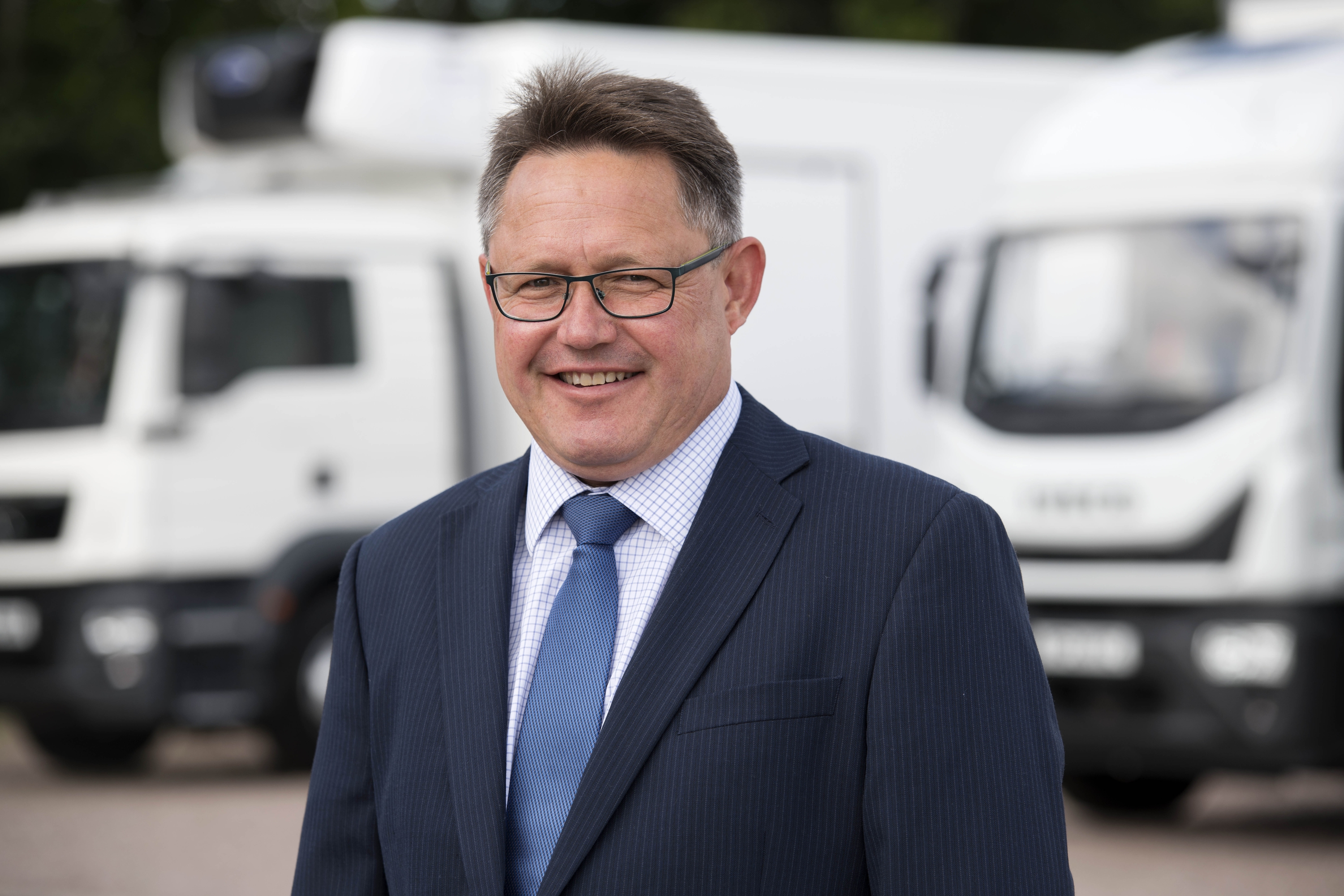 James Hunter, truck and trailer's Head of Sales, In Front of a Truck