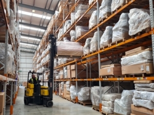 HSL Chairs - forklift putting sofa on high storage