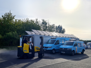Dawsongroup's Environmental Commitment - forklift truck and two Jude's Ice Cream vans in front of solar powered cold storage unit