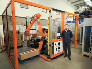Marcus Worrall in front of the PalPro automated end-of-line palletisation robot