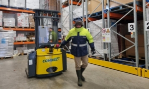 Combilift investment - worker pulling cold store Combilift in chilled warehouse