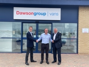 Dawsongroup vans team receiving Ford Warranty Approval in front of Dawsongroup vans signs.
