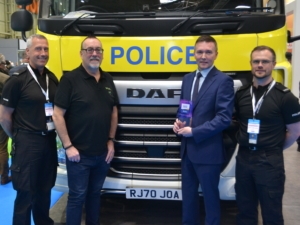 Dawsongroup truck and trailer team receiving National Highways Award in front of tractor unit with elevated cab.