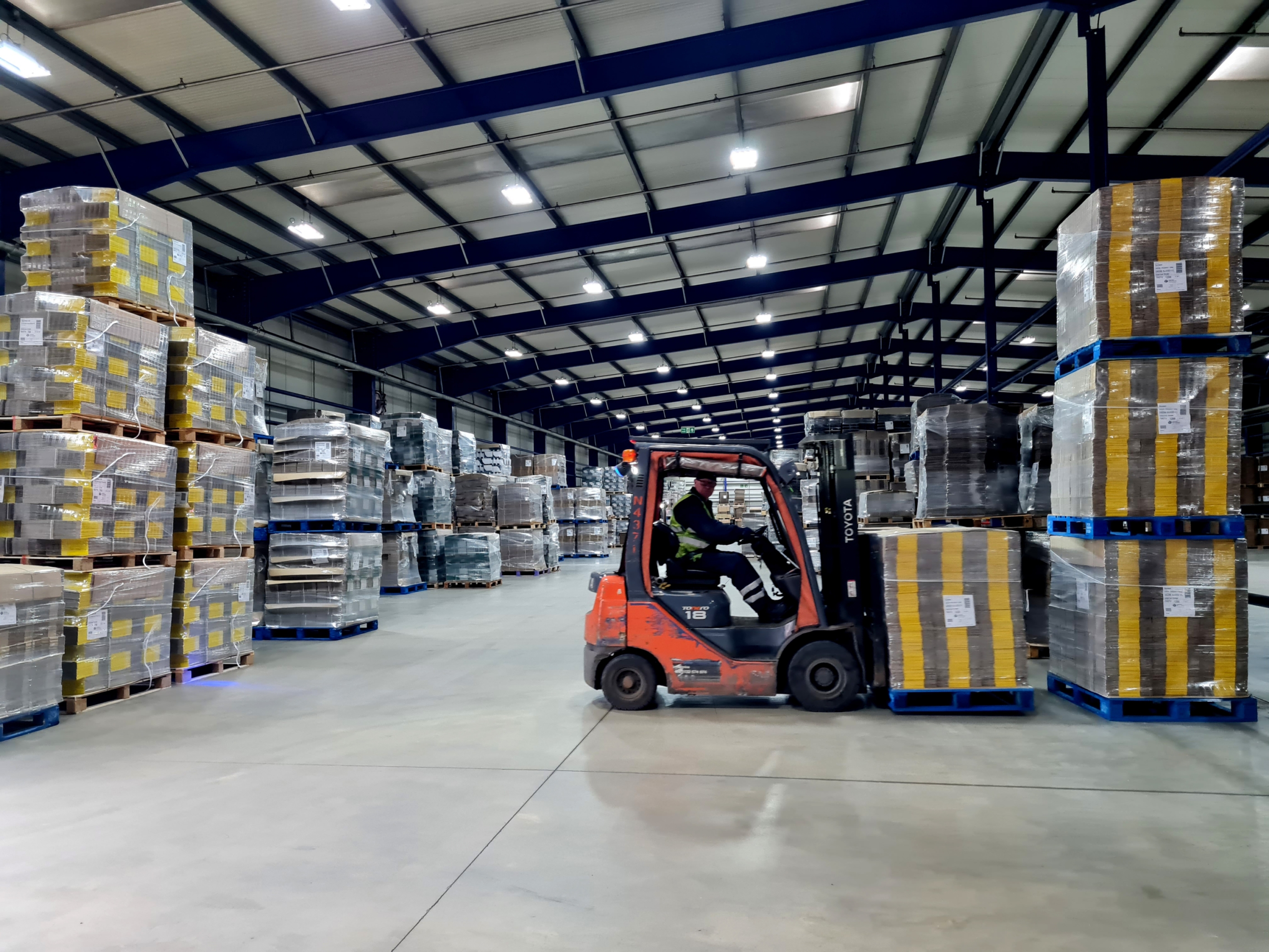 Sheard's Sustainable Fleet - forklift moving pallets in a warehouse