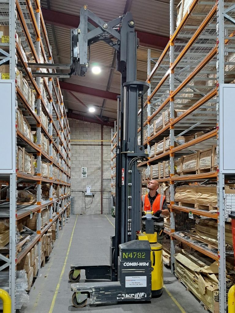Counterbalance forklift used by employee, trebling storage capacity in the Kudos Showers warehouse.