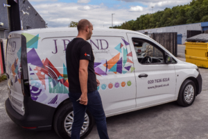 J Brand employee walking in front of vehicles provided by Dawsongroup vans