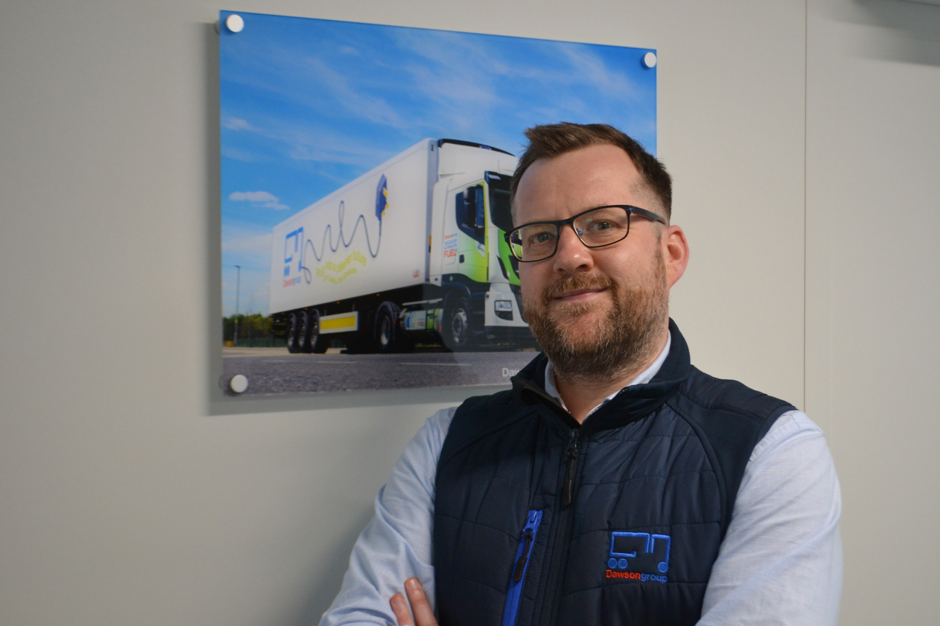 Stuart Gray, standing in front of a Dawsongroup truck and trailer image.