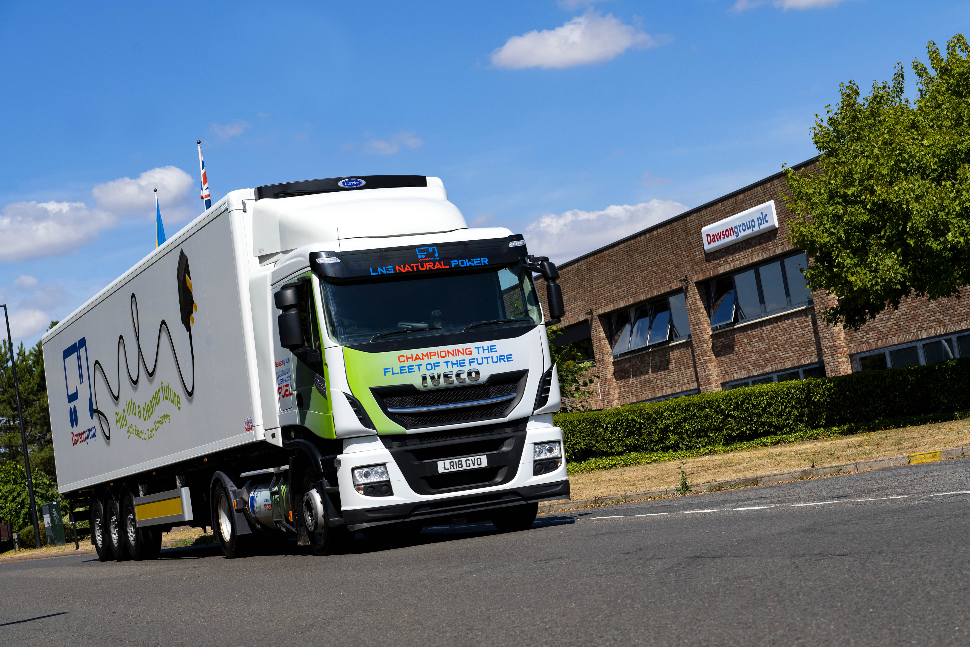 eCool trailer with Dawsongroup branding, driving on a sunny day, in front of the Dawsongroup head office, showcasing how upgrading your fleet to smarter, more efficient assets can benefit your company